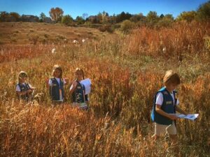 Scouts hiking through a field
